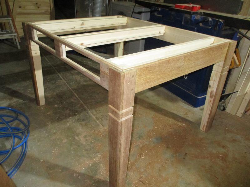 Between the table frame sit the rails for the drawers
